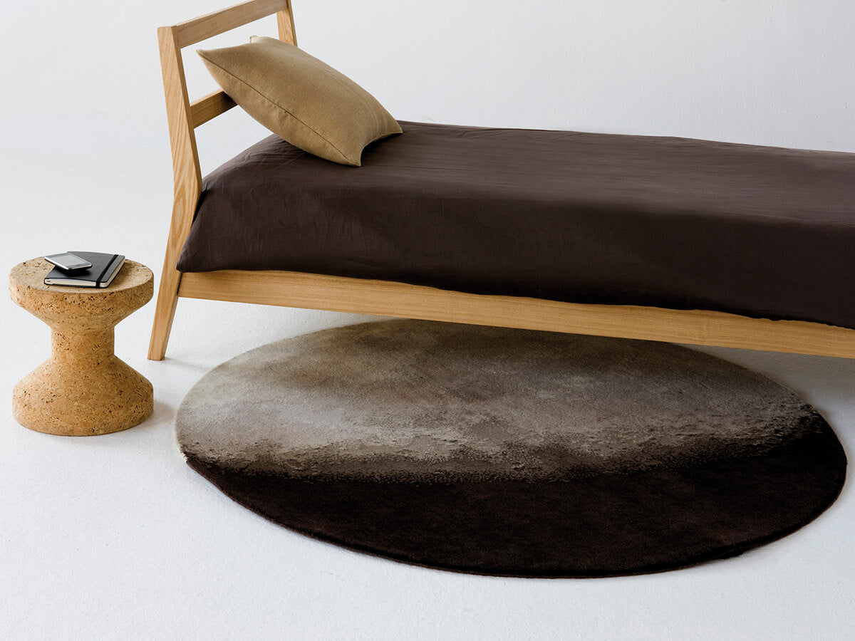 Luna rug beside a bed and bedside table